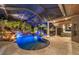 Outdoor kitchen and pool area with waterfall feature at 11432 Savannah Lakes Dr, Parrish, FL 34219