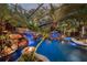 Enclosed pool area with waterfall at night at 11432 Savannah Lakes Dr, Parrish, FL 34219