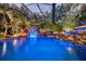 Stunning pool with waterfall and tropical landscaping at 11432 Savannah Lakes Dr, Parrish, FL 34219