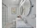 Modern bathroom with double vanity and walk-in shower at 120 Edgewater Ter, Dunedin, FL 34698