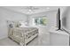 Bedroom with a queen bed and window seat at 120 Edgewater Ter, Dunedin, FL 34698