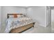 Guest bedroom with queen-size bed and built-in shelving at 120 Edgewater Ter, Dunedin, FL 34698