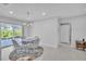 Elegant dining room with a round table and chairs, and access to the patio at 120 Edgewater Ter, Dunedin, FL 34698