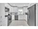 Newly remodeled kitchen with white cabinets and stainless steel appliances at 120 Edgewater Ter, Dunedin, FL 34698