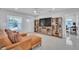 Bright living room features a comfy sectional sofa and built-in shelving at 120 Edgewater Ter, Dunedin, FL 34698