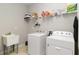 Convenient laundry room with washer, dryer, and utility sink at 12458 Marsh Pointe Rd, Sarasota, FL 34238