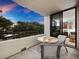 Evening view from balcony with table and chairs, overlooking tranquil waters at 1255 N Gulfstream Ave # 204, Sarasota, FL 34236