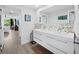 Bright bathroom with double vanity and view of bedroom at 1255 N Gulfstream Ave # 204, Sarasota, FL 34236