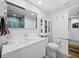 White bathroom with single vanity, toilet, and storage cabinet at 1255 N Gulfstream Ave # 204, Sarasota, FL 34236