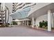 Modern building entrance with glass canopy and paved courtyard at 1255 N Gulfstream Ave # 204, Sarasota, FL 34236