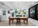 Bright dining room with a wood table, stylish light fixture, and artwork at 1255 N Gulfstream Ave # 204, Sarasota, FL 34236