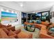 Spacious living room with large TV, hardwood floors, and access to balcony at 1255 N Gulfstream Ave # 204, Sarasota, FL 34236