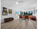 Spacious living room with large TV, hardwood floors, and access to balcony at 1255 N Gulfstream Ave # 204, Sarasota, FL 34236