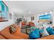 Spacious living room with large TV, hardwood floors, and access to balcony at 1255 N Gulfstream Ave # 204, Sarasota, FL 34236
