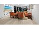 Spacious living room with large TV, hardwood floors, and access to balcony at 1255 N Gulfstream Ave # 204, Sarasota, FL 34236