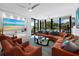 Spacious living room with large TV, hardwood floors, and access to balcony at 1255 N Gulfstream Ave # 204, Sarasota, FL 34236