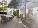 Outdoor patio area with seating, tables, and shade umbrella at 1255 N Gulfstream Ave # 204, Sarasota, FL 34236