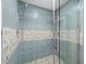 Walk-in shower with pebble tile and glass enclosure at 1255 N Gulfstream Ave # 204, Sarasota, FL 34236