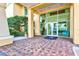 Building entrance with brick walkway and glass doors at 130 Riviera Dunes Way # 1104, Palmetto, FL 34221