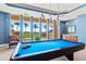 Relaxing game room with billiard table, seating area, and water views at 130 Riviera Dunes Way # 1104, Palmetto, FL 34221