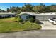Aerial view of a light blue house with a garage and car at 1312 Stafford Ln # 1427, Sarasota, FL 34232
