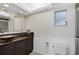 Bathroom with dark brown vanity, vessel sink, and tiled shower at 1312 Stafford Ln # 1427, Sarasota, FL 34232
