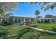 Two light blue houses with a walkway, green lawn, and palm trees at 1312 Stafford Ln # 1427, Sarasota, FL 34232