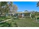 Ranch-style home with manicured lawn and lush landscaping at 1312 Stafford Ln # 1427, Sarasota, FL 34232
