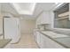 White kitchen with appliances and green tile backsplash at 1312 Stafford Ln # 1427, Sarasota, FL 34232