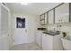 Laundry room with washer, dryer, cabinets, and exterior access at 1312 Stafford Ln # 1427, Sarasota, FL 34232