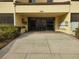 Condo building entrance with mailboxes and landscaping at 13612 South Village Dr # 105, Tampa, FL 33618
