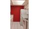 Efficient kitchen featuring white appliances and red walls at 13612 South Village Dr # 105, Tampa, FL 33618