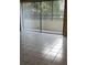 Condo living area with tiled floors and access to balcony at 13612 South Village Dr # 105, Tampa, FL 33618