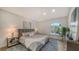 Bright bedroom with king-size bed and large window at 1410 Siesta Dr, Sarasota, FL 34239