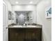 Double vanity bathroom with granite countertops and a large mirror reflecting a shower at 14339 Easy Goer St, Ruskin, FL 33573
