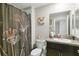 Bathroom with shower/tub combo, granite countertop, and floral shower curtain at 14339 Easy Goer St, Ruskin, FL 33573
