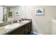 Double vanity bathroom with granite countertops and a large mirror at 14339 Easy Goer St, Ruskin, FL 33573