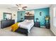 Bedroom with dark wood furniture and a teal accent wall at 14339 Easy Goer St, Ruskin, FL 33573