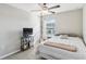 Bright bedroom with a comfortable bed, TV stand, and ceiling fan at 14339 Easy Goer St, Ruskin, FL 33573