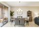 Elegant dining room with a large wooden table and a chandelier at 14339 Easy Goer St, Ruskin, FL 33573