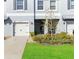 Front view of townhome with a 2-car garage and landscaped lawn at 14339 Easy Goer St, Ruskin, FL 33573