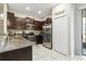 Modern kitchen with dark cabinets, stainless steel appliances, and granite countertops at 14339 Easy Goer St, Ruskin, FL 33573