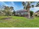 Landscaped backyard with screened patio and lush lawn at 150 Mestre Pl, North Venice, FL 34275