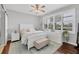 Comfortable bedroom with white furniture, ceiling fan, and hardwood floors at 150 Mestre Pl, North Venice, FL 34275