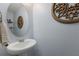 Small bathroom with pedestal sink and decorative mirror at 15404 Trinity Fall Way, Bradenton, FL 34212
