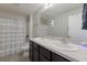 Clean bathroom with double sinks and decorative shower curtain at 15404 Trinity Fall Way, Bradenton, FL 34212