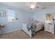 Light blue bedroom with white furniture, ceiling fan and window coverings at 15404 Trinity Fall Way, Bradenton, FL 34212