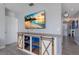 Entryway with farmhouse-style media console and view into hallway at 15404 Trinity Fall Way, Bradenton, FL 34212