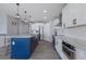 Modern kitchen with blue island, white cabinets, and stainless steel appliances at 15404 Trinity Fall Way, Bradenton, FL 34212