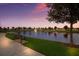 Serene lake view with fountain and bench at sunset at 15404 Trinity Fall Way, Bradenton, FL 34212
